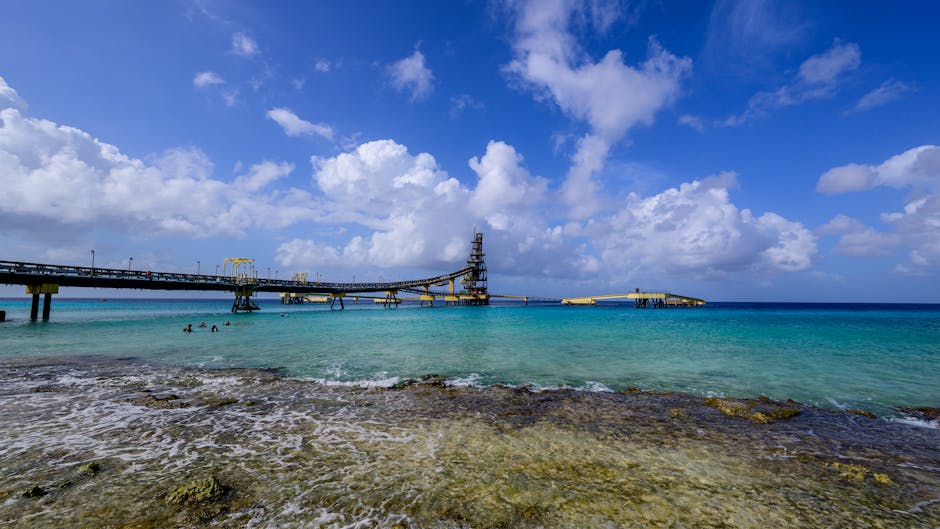 Beautiful coastal view with a pier extending into the turquoise Caribbean Sea in Bonaire.