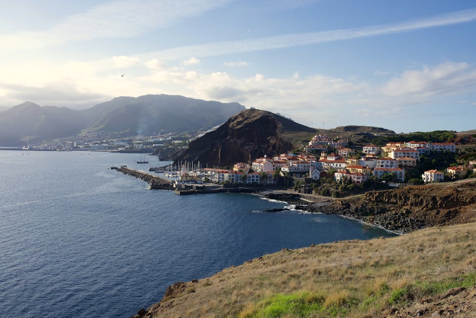 Scenic view of Madeira's stunning coastline with a charming village nestled  the sea.