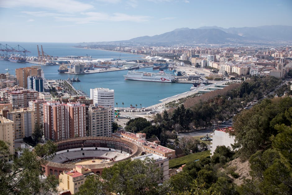 Stunning aerial view of Málaga, Spain, showcasing the port and coastline.