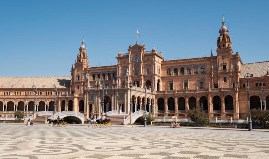 Stunning view of Plaza de España, Seville, showcasing its magnificent architecture under a clear blue sky.