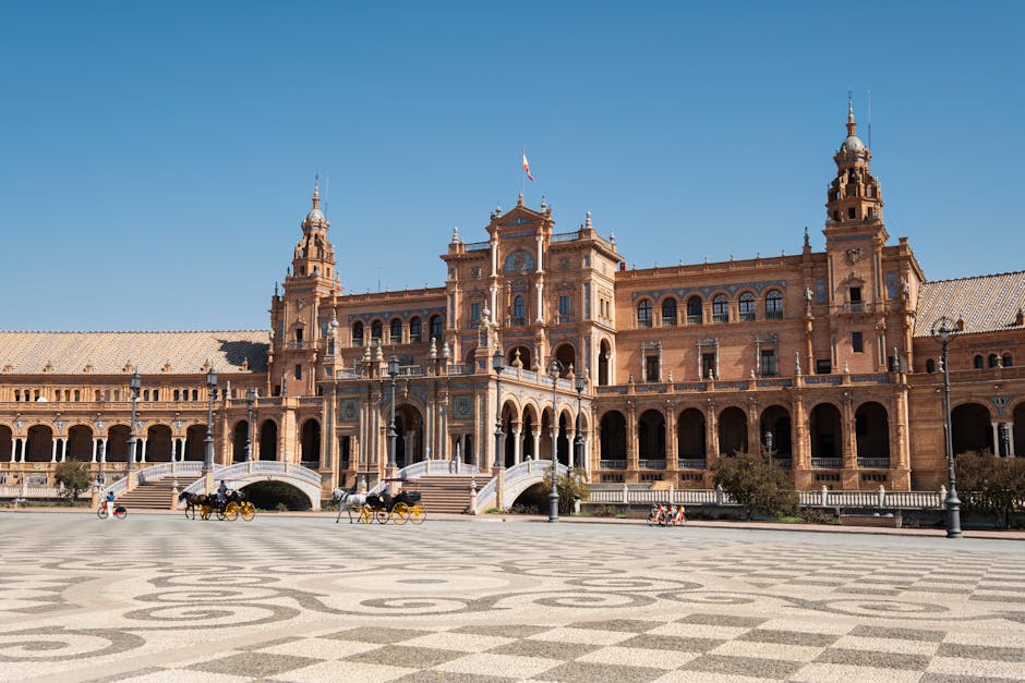 Stunning view of Plaza de España, Seville, showcasing its magnificent architecture under a clear blue sky.