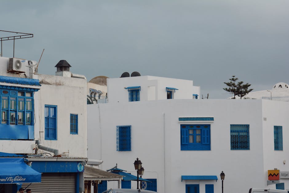 Charming white buildings with blue accents in the historic district of Carthage, Tunisia.
