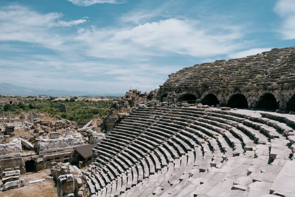 Explore the ancient Roman amphitheater ruins in Side, Türkiye under a clear blue sky.