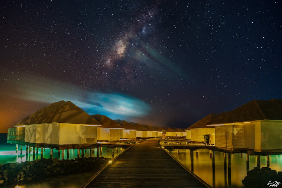 Capture o céu noturno deslumbrante e as vilas de luxo nas Maldivas, com vista para a Via Láctea.